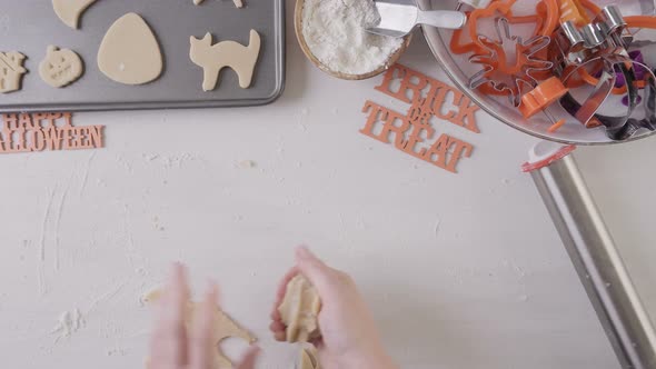 Step by step. Mother and daughter making Halloween sugar cookies. alt
