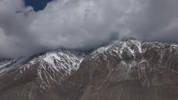 Ominous Clouds Above Peaks Of Snow Covered Mountains In Hunza Pakistan