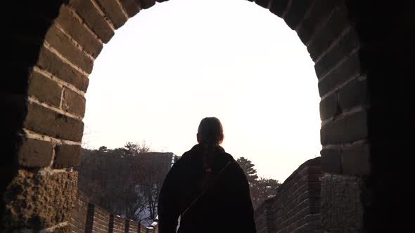 Happy Woman Walk at Great Wall of China Come Down From Watch Tower at Badaling Section at Sunset in