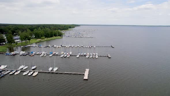 Drone footage of sailboats in harbors at Mardorf, Steinhuder Meer lake. alt