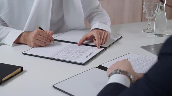Arab Man Sign Financial Documents with a Partner Businessman While Sitting in the Office Handshake alt
