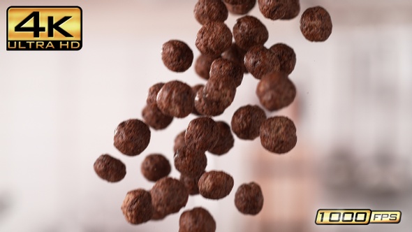 Handful of Falling Chocolate Ball-Shaped Cereals alt