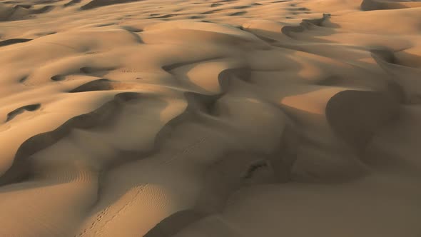  Aerial Drone View Flying By Beautiful Wavy Sand Dunes in Golden Sunset Light alt