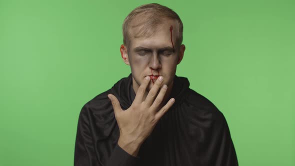 Man Executioner Halloween Makeup and Costume. Guy with Blood on His Face alt