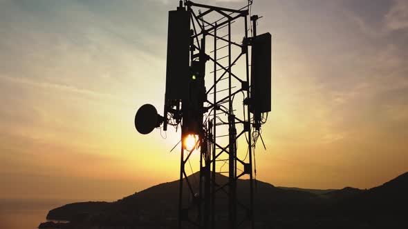 Amazing closeup sunset drone view of silhouette of cell tower