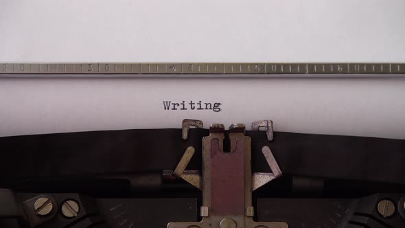 Typing word Writing on retro typewriter. Close up. alt
