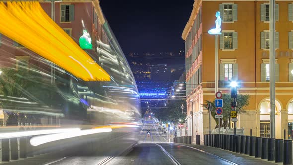 Night Cityscape with Moving Tram on Massena Square in Downtown Timelapse alt