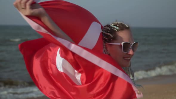 Beautiful Woman with the Flag of Turkey on the Sea Beach Slow Motion alt