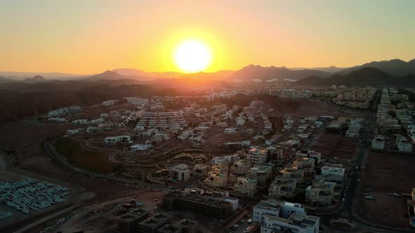 Aerial View of Sunset Over a Small Town in the Mountains