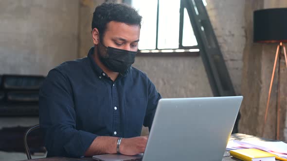 Hindu Mixedrace Male Employee Wearing Protective Face Mask Working in the Office alt