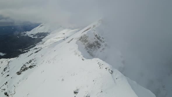 Drone View of the Slopes of the Black Pyramid Mountain in Winter Covered in Snow alt