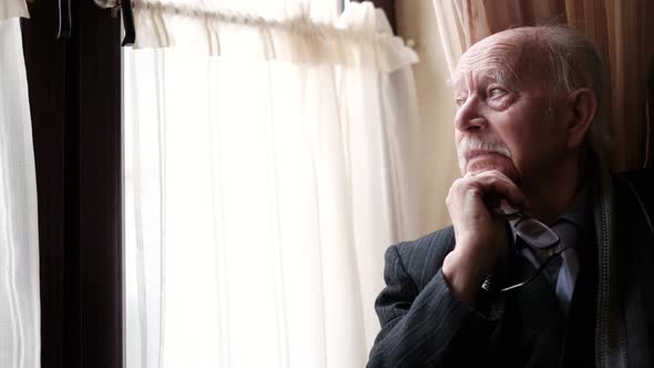 Senior Retiree at Home in the Kitchen Feeling Worried About Health Problems alt