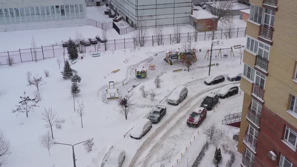 A Snow Blower Removes Snow on the Playground with the Help of Special Equipment in the Courtyard of