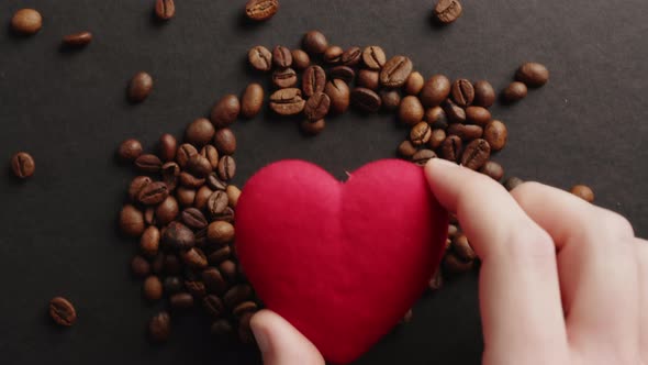 Red Heart Resting on Coffee Beans alt