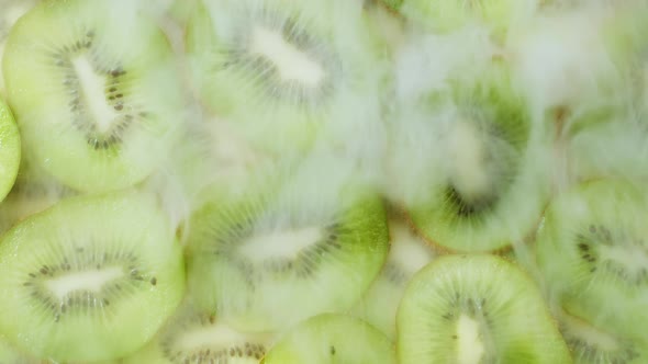 Chilled Kiwi Slices with Cold Steam Smoke. Close-up of Green Juicy Texture with Seeds of Exotic alt
