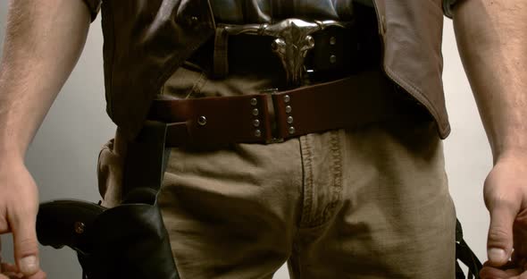 Close up of a cowboy with a gun, holding onto his belt with a bull on it, 4k alt