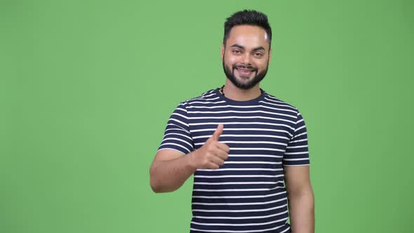 Young Happy Bearded Indian Man Giving Thumbs Up