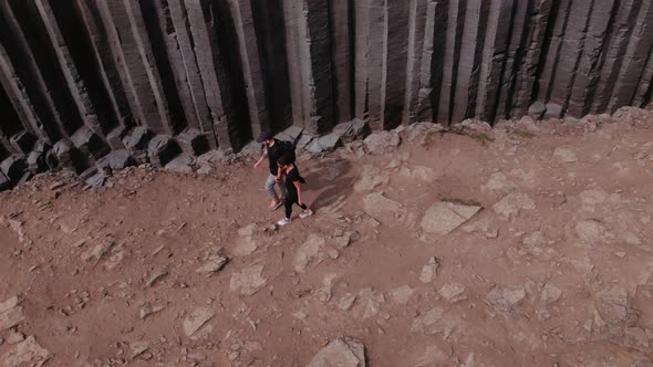 Male and Female Tourists Walking Along the High Cliffs  Studlagil Canyon alt