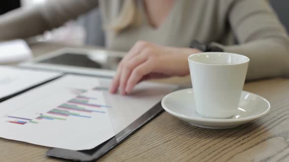 Business Woman Works with the Charts on the Tablet alt