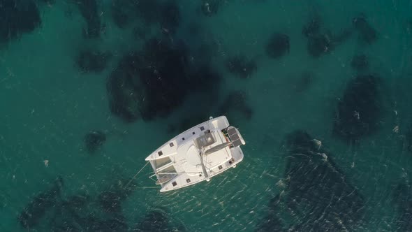 Aerial view of a catamaran anchored in Aegean sea, Greece. alt