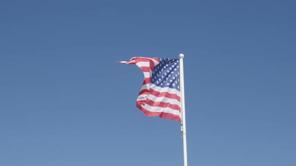 United States of America flag fabric against blue sky 4K 2160 30fps UHD footage -  American symbol i