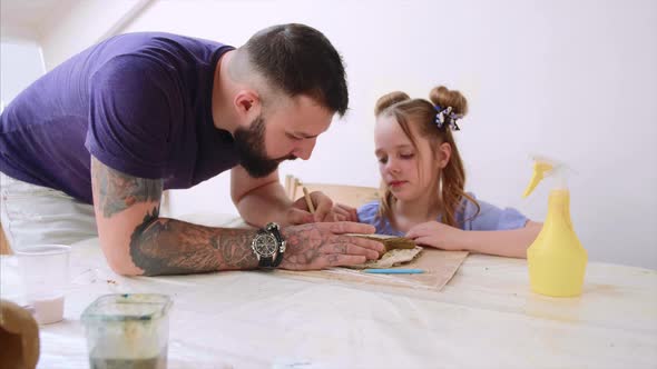 Teacher Explains and Shows His Pupil Girl How to Modeling a Toy From Clay