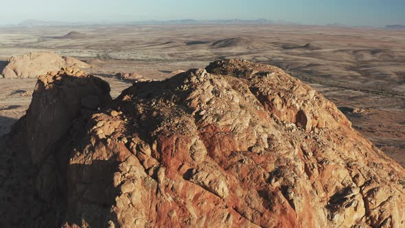 Close Up Of Rugged Peak And Desert Landscape In Spitzkoppe, Namibia. drone pullback alt