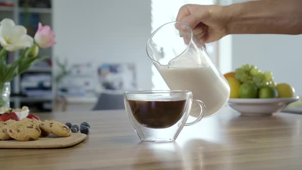 Pouring Milk In To Coffee