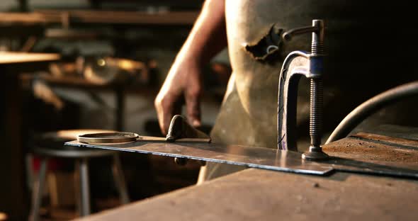 Mid-section of welder working alt