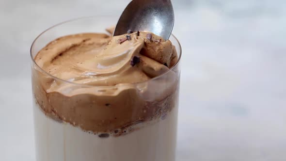 Cold Korean Dalgona Coffee. Drink with Cold Milk and Coffee Cream Foam in Glass. alt