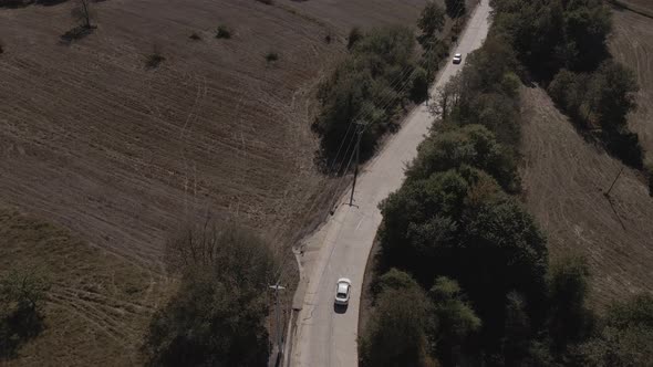 aerial car chasing on dirt road
