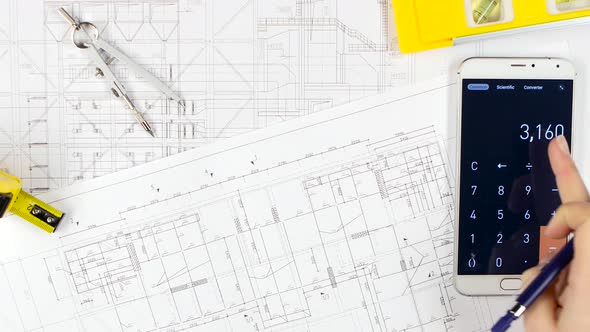 Architects Compare the Calculations with the Drawing, and Discuss Further Cooperation. Close Up alt