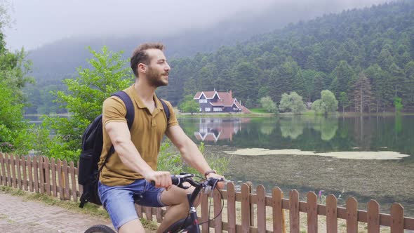 Cycling on the forest road. alt