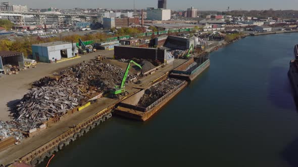 Aerial View of Machinery Loading Metal Scrap on Cargo Boat alt
