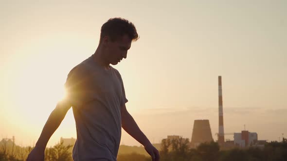 A cool man walks against the backdrop of a beautiful sunset. Slow motion alt