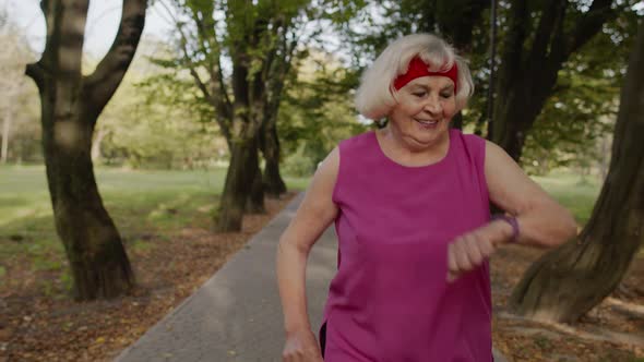Senior Runner Woman Training Outside, Enjoying Nature. Workout Cardio at Morning. Healthy Lifestyle alt