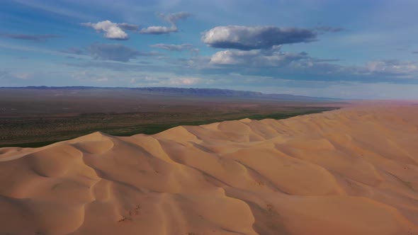 Aerial View of Sand Dunes in Desert at Sunset alt
