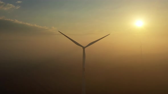 Windmills in Rotation at Fog Sunrise alt