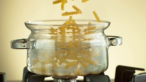 Super Slow Motion Shot of Fresh Fusilli Falling Into Boiling Salted Water at 1000 Fps alt