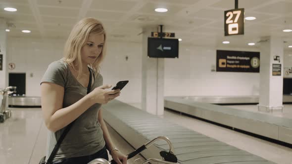 Young Adult Female waiting for luggage in airport