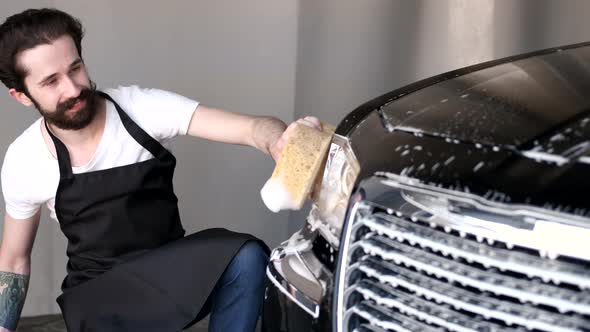 Man Washing His Car in a Garage alt