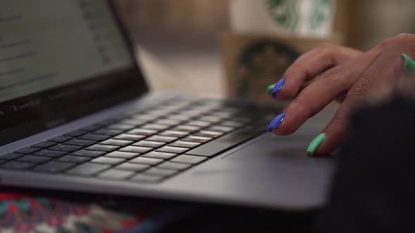 Woman with Manicure Slides Touchpad of Expensive Laptop alt