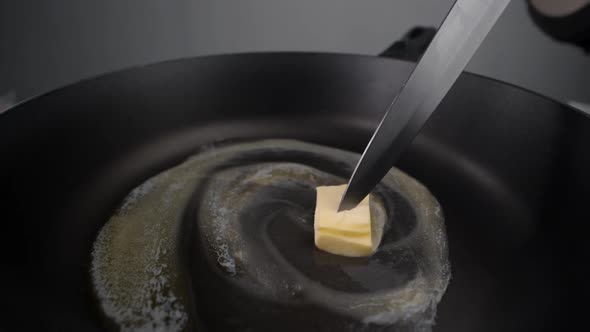 Chef Greases the Hot Pan with Butter, Melting Butter on the Pan, Butter on the End of the Knife