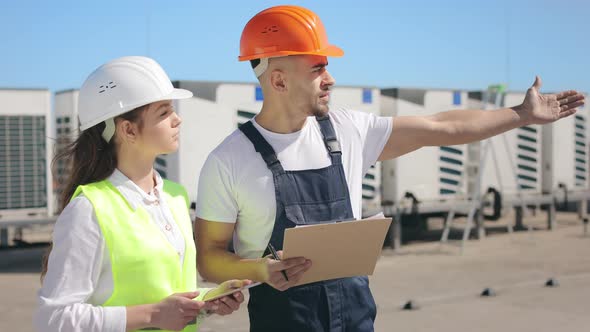 two-engineers-are-discussing-the-work-done-to-install-the-air