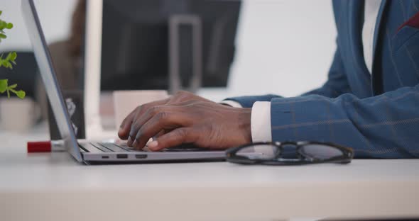 Close Up of African Businessman Coughing and Scarying Female Colleague Sitting Near Him alt