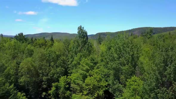 Drone Flying Above Green Hilltops alt