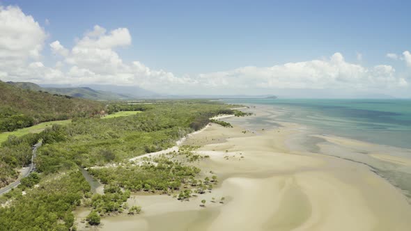 Aerial, Low Tide And Huge Sand Ocean Bed And Mangroves Growing In Queensland Australia