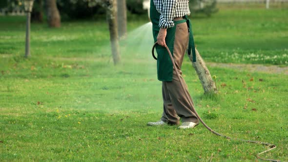 Senior Man Holding Water Hose. alt
