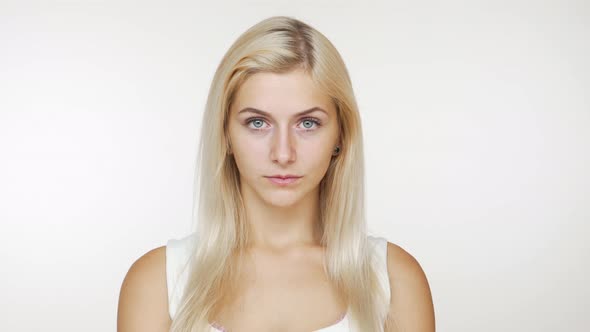 Young Blond Woman Feeling Upset Frustrated Looking at Camera with Tricky Eyes Raising Her Eyebrow alt