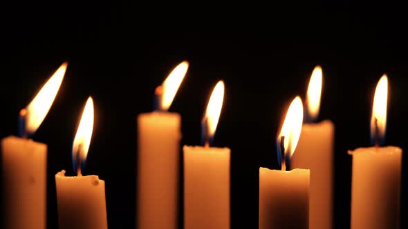 Close up view of candlelight burning in the dark